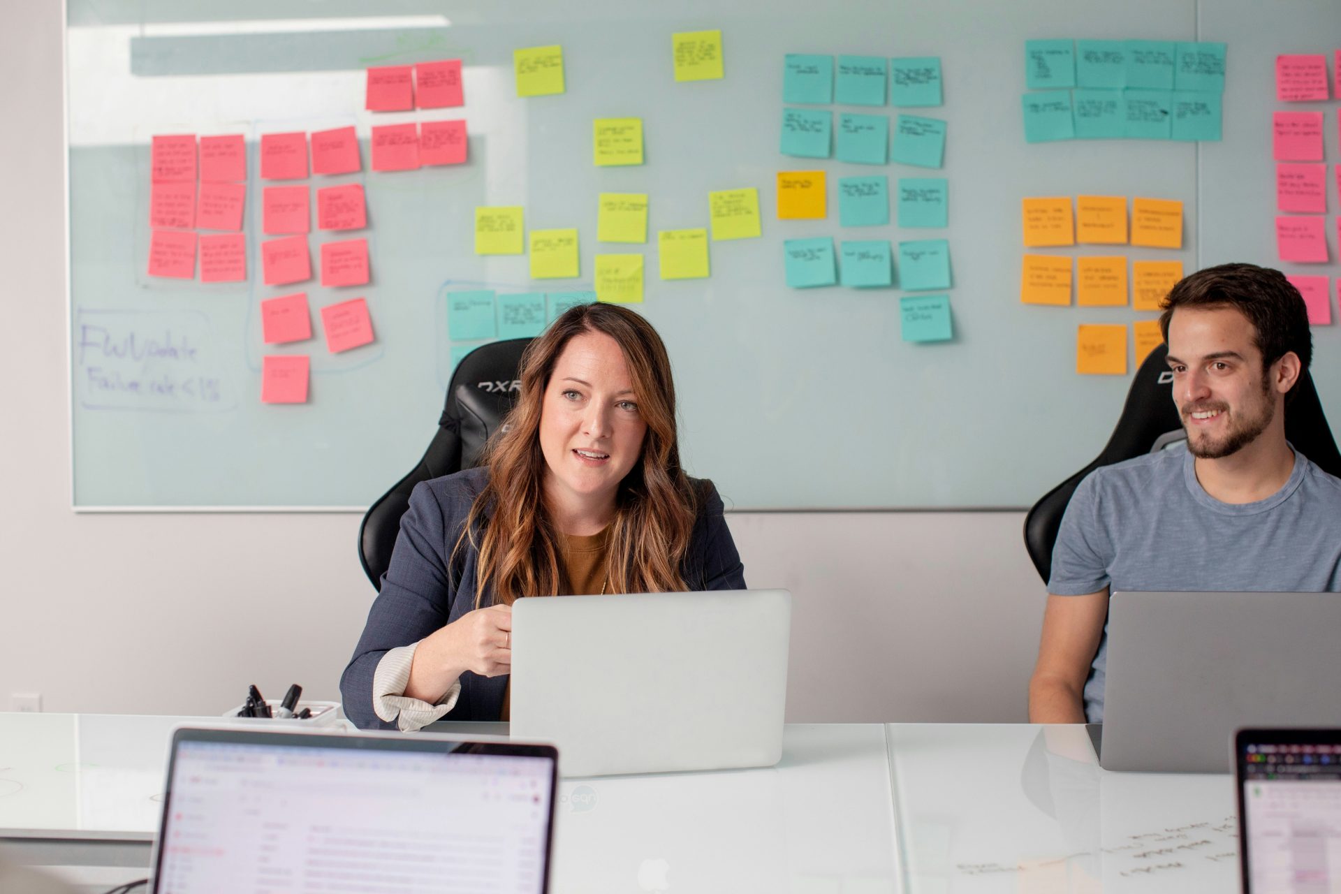 Two colleagues brainstorming with post-it notes.
