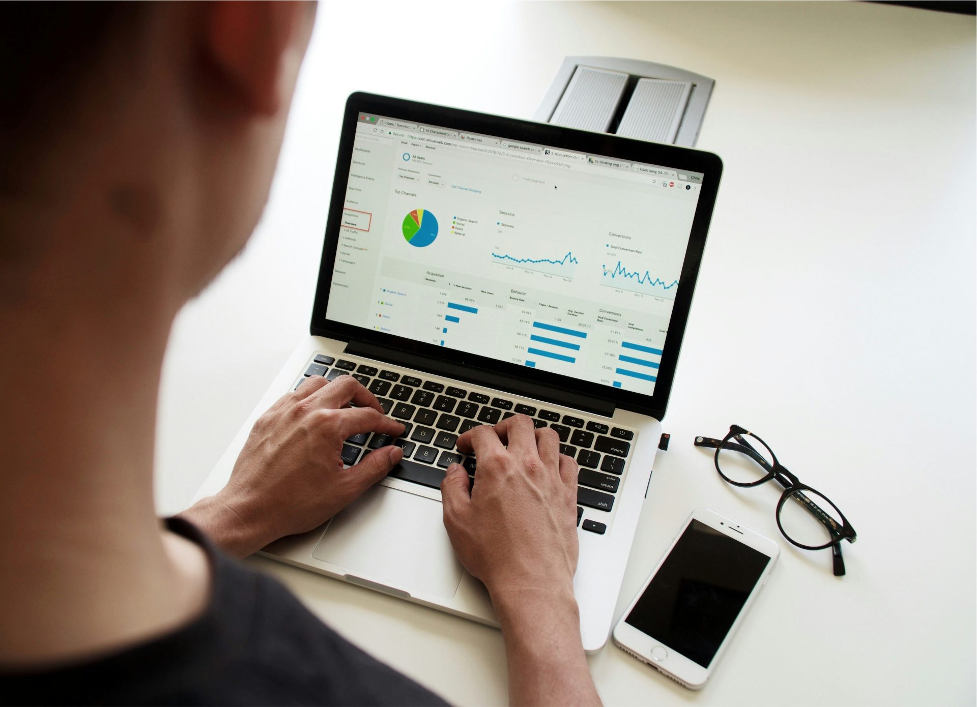 User analysing data charts on a laptop.