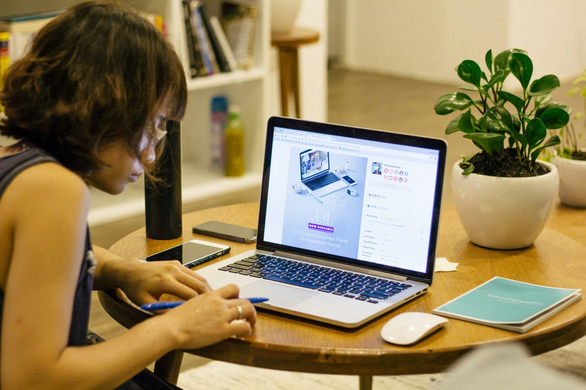 Woman focused on digital work with plants.